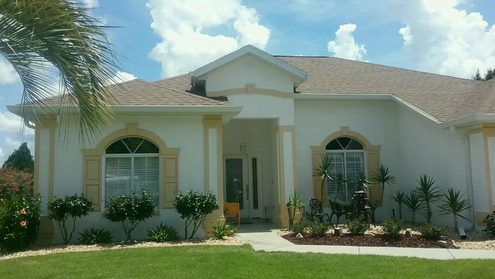 Florida home with arched windows and seamless gutters