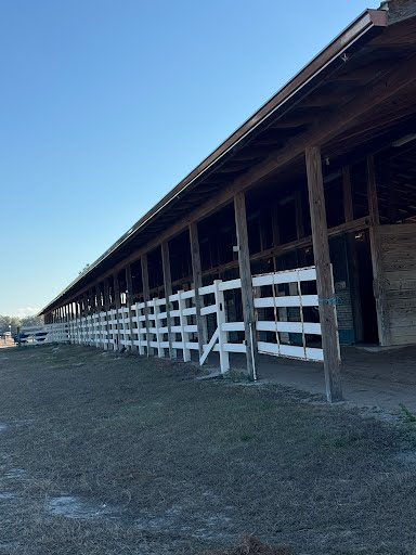 Large barn with white board fencing installation